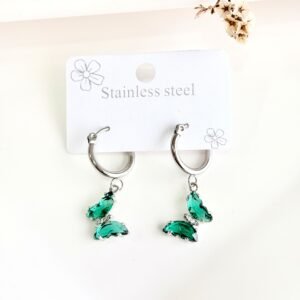 Aros de acero, argolla, dije de mariposa con piedras verdes.