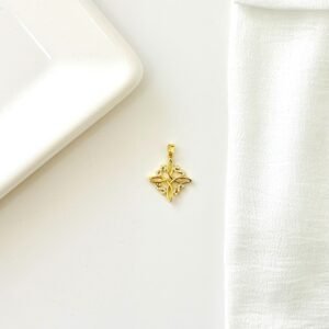Dije nudo de bruja dorado con strass.
