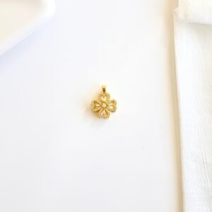 Dije giratorio dorado con piedras y strass.