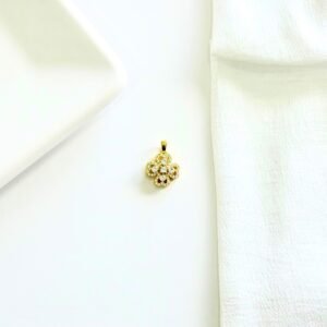 Dije giratorio dorado con piedras y strass.